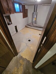Laundry room under construction after floor patching.