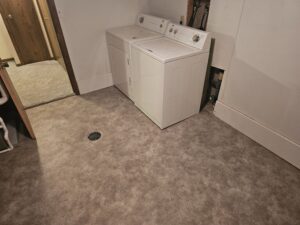 Laundry room after new sheet vinyl flooring.