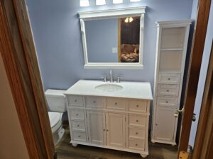 bathroom remodel with white cabinets and vinyl plank flooring