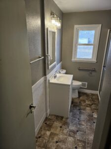 Bathroom remodel with wainscot and sheet vinyl