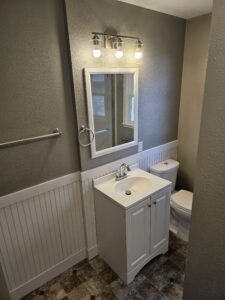 Bathroom remodel with wainscot and sheet vinyl
